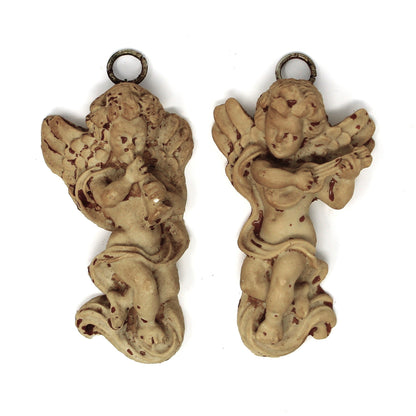 Pair of decorative cherub figurines.