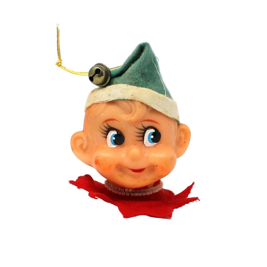 Vintage-style elf figurine light cover, with a green hat, bell and red outfit.