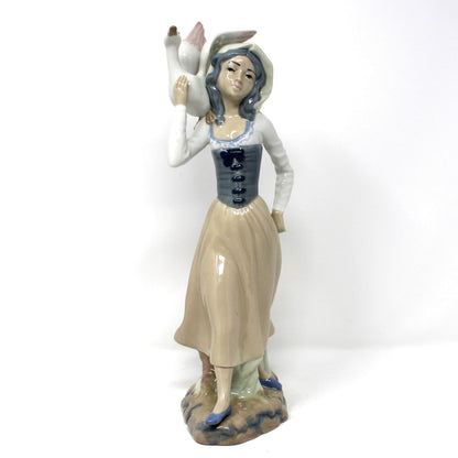 Vintage Casades Porcelain sculpture.  Woman holding a goose.  