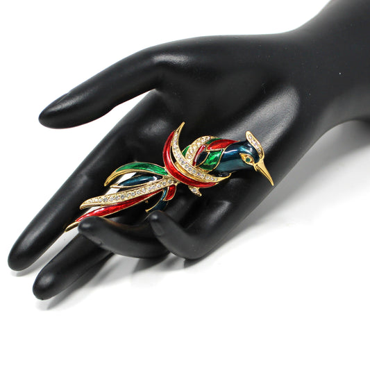 A colorful vintage brooch signed D'Orlan. Enamel bird brooch with gold-tone metal, red, green, and blue enamel, and clear rhinestones.