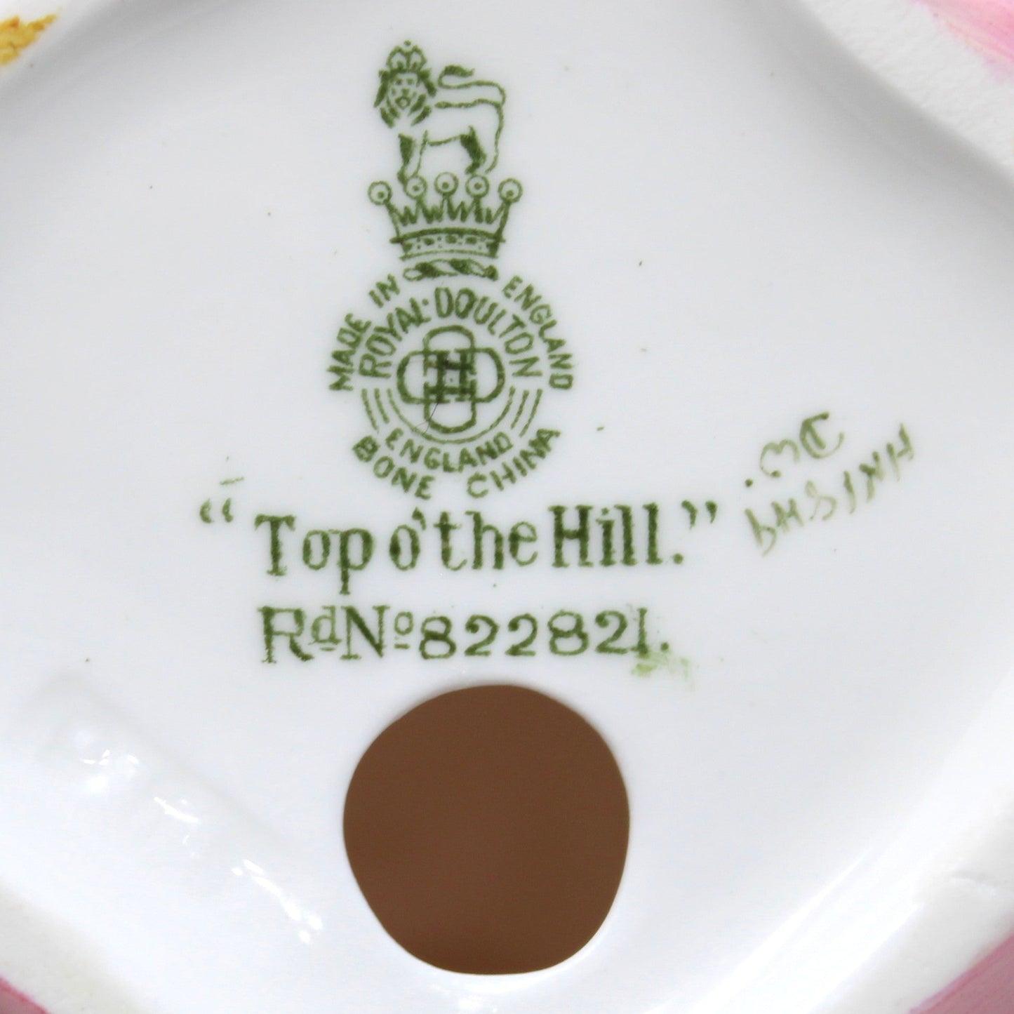 Close up view of Royal Doulton's marker's  mark on vintage porcelain Royal Doulton figurine titled "Top O' The Hill". HN1849, bone china, England