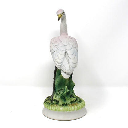 Side view of A vintage ceramic bird figurine depicting a white heron standing on a green textured base.  Angeline Originals, Japan.