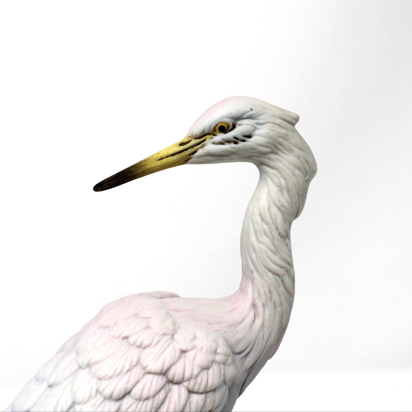 A close up view of face on white heron figurine shown in profile. Vintage bisque porcelain, Angeline Originals, Japan