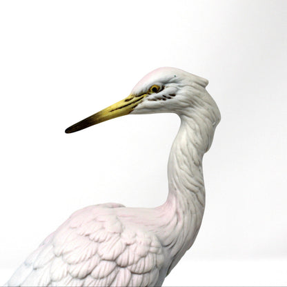 A close up view of face on white heron figurine shown in profile. Vintage bisque porcelain, Angeline Originals, Japan