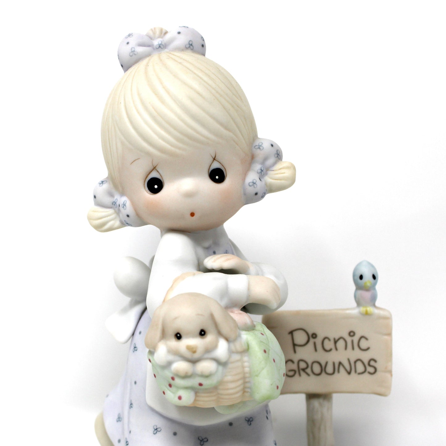 A close up view of the vintage Precious Moments figurine from the Calendar Girls collection, titled July. 