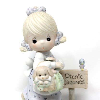 A close up view of the vintage Precious Moments figurine from the Calendar Girls collection, titled July. 