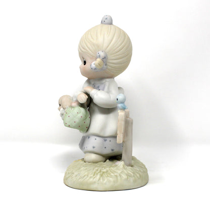 Side view of the vintage Precious Moments figurine from the Calendar Girls collection, titled July.  