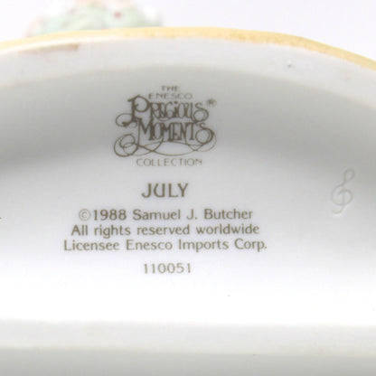 The underside of a ceramic July figurine from Precious Moments Calendar Girls Collection, July 1988