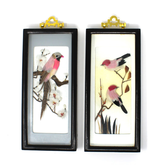 A pair of vintage Japanese bird feather dioramas, framed in black lacquer shadow boxes with brass decorative hooks.