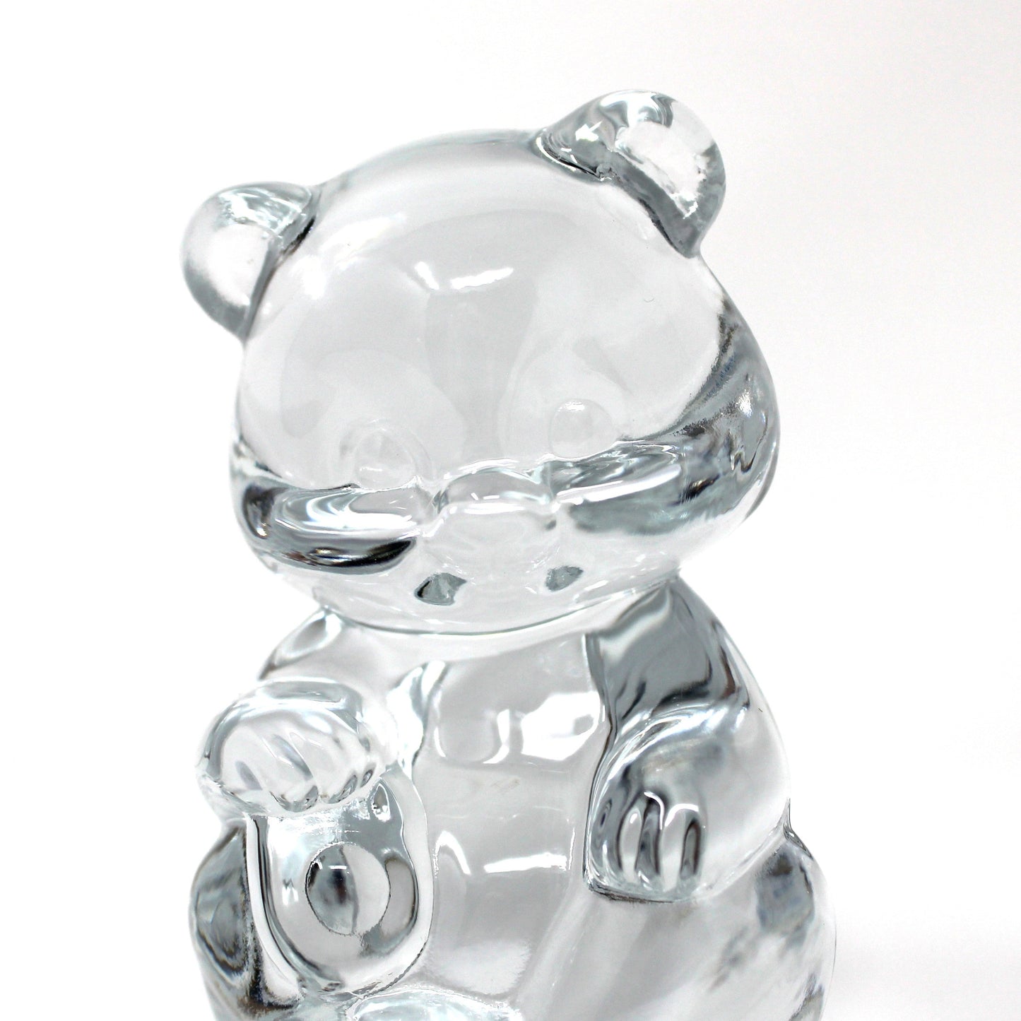 close up view of a vintage Fenton clear glass bear figurine / paperweight sitting upright.