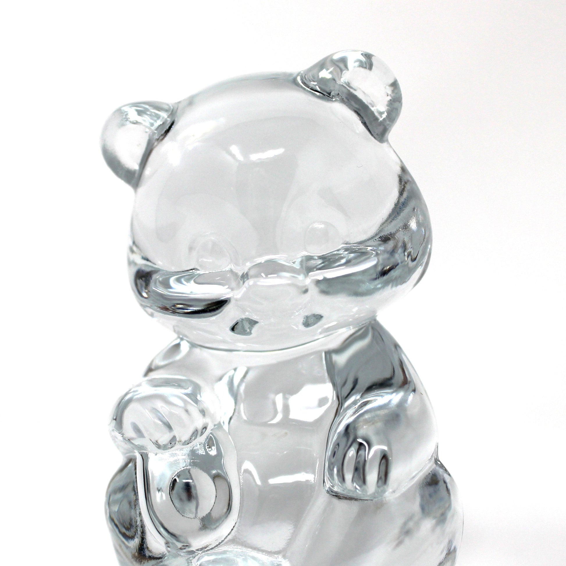 close up view of a vintage Fenton clear glass bear figurine / paperweight sitting upright.