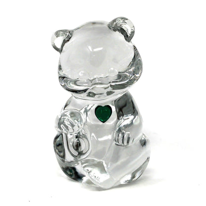 A small clear crystal bear charm with a green heart detail on its chest, shown against a plain white background.