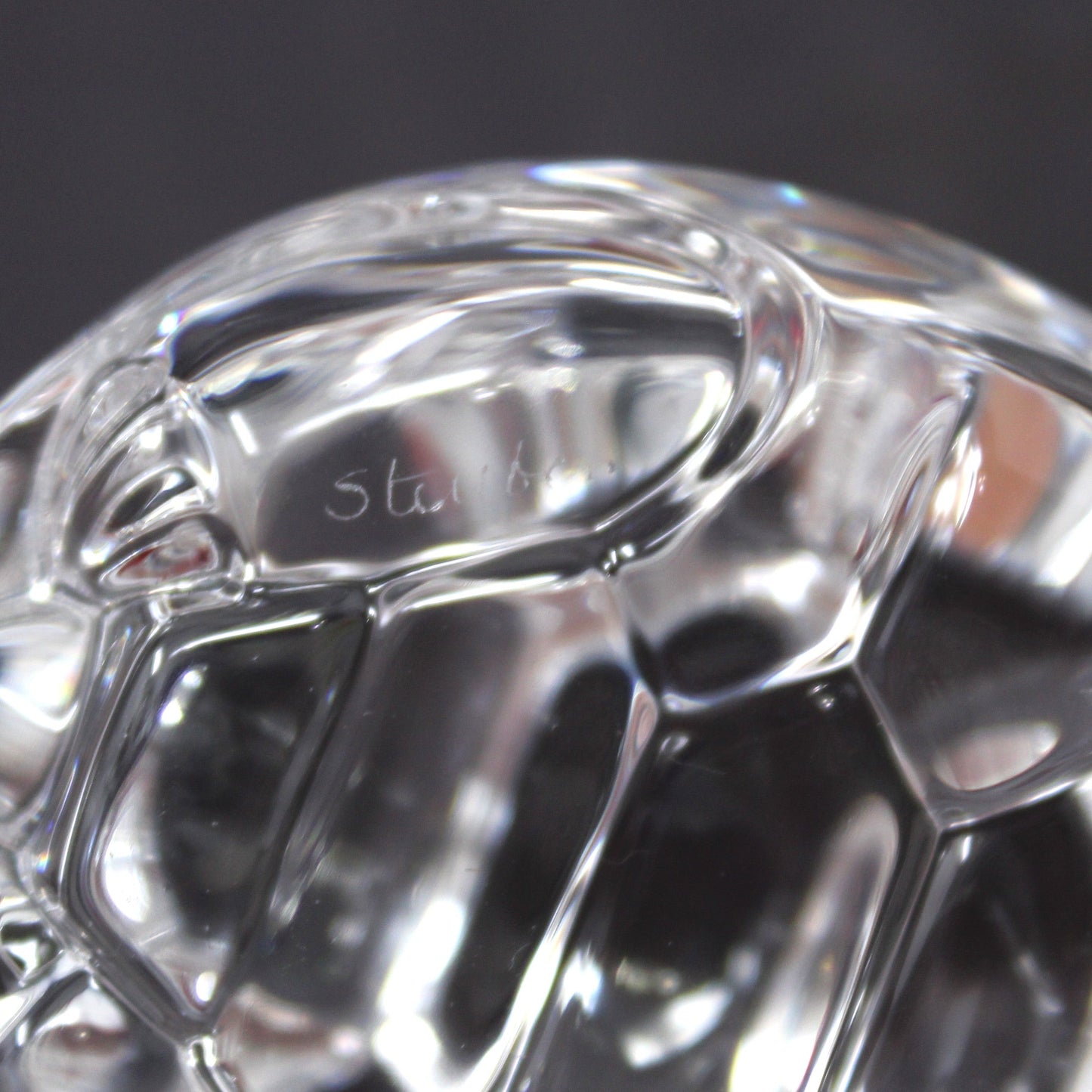 A close-up view of Steuben etched signature on crystal turtle
