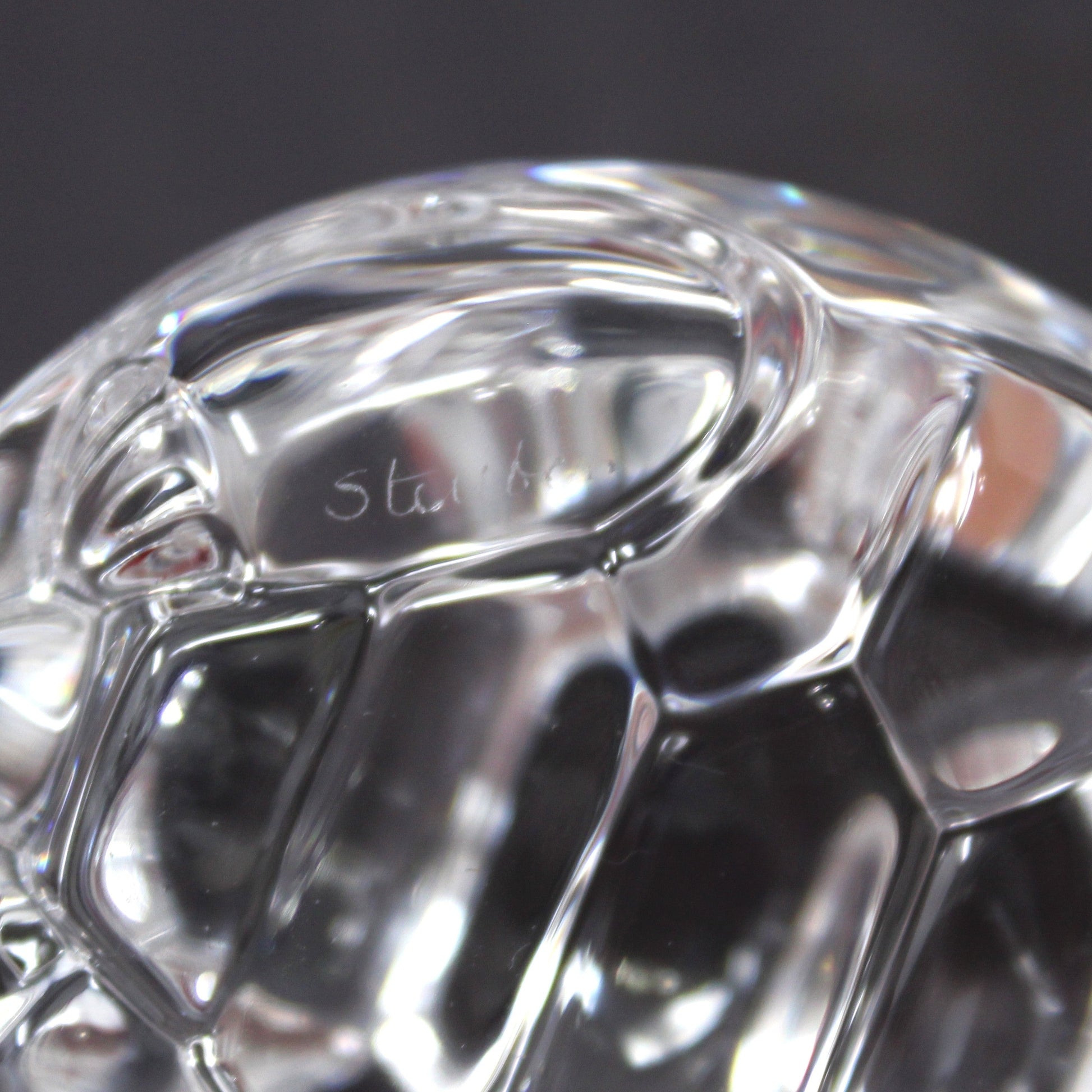 A close-up view of Steuben etched signature on crystal turtle
