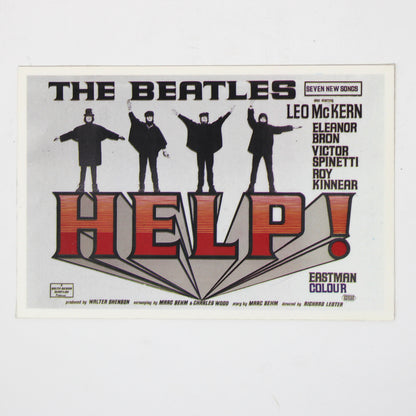 A vintage concert postcard for The Beatles' 'Help!' album, featuring the band members in black silhouettes above large red and black 'HELP!' lettering