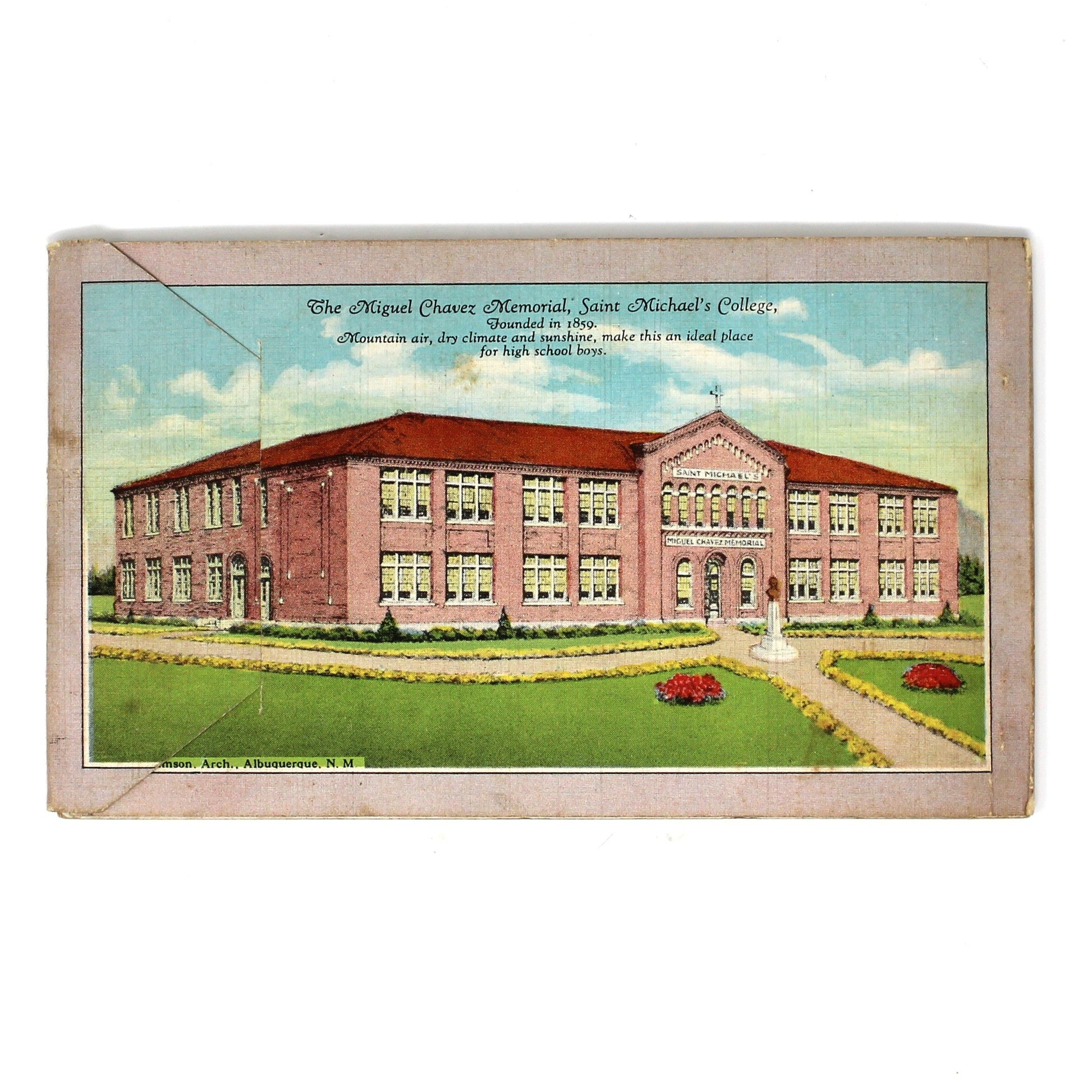 A vintage printed postcard or card featuring an illustration of a large brick building with green lawn and blue sky, centered on a plain white background.