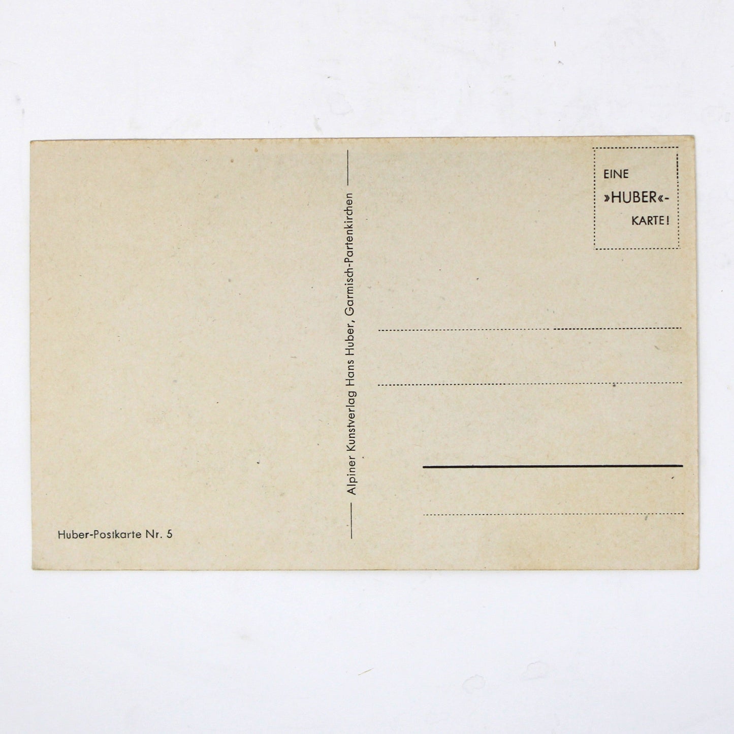 Back view of a vintage postcard with printed lines and text, picture by Hans Huber.