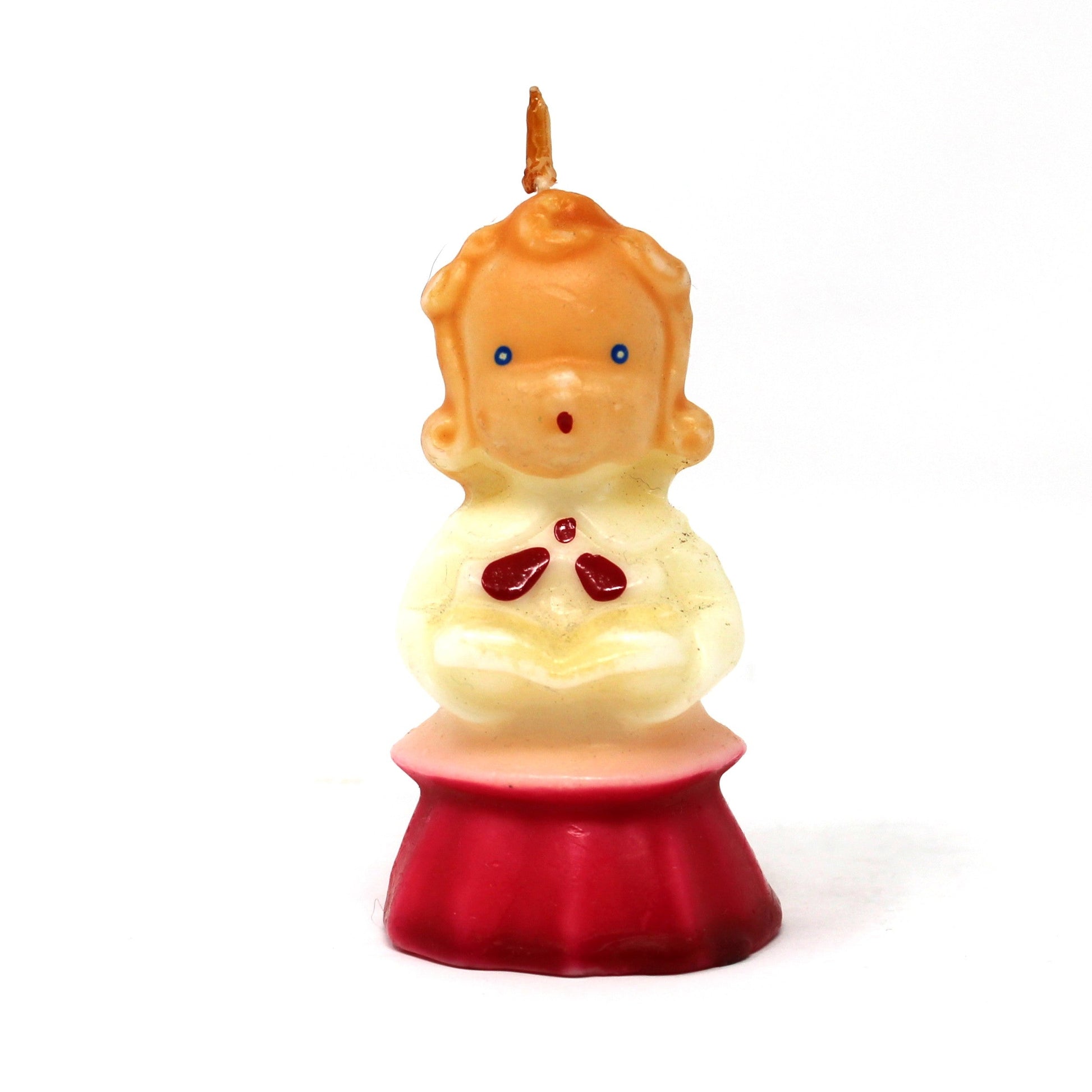 A vintage Gurley novelty candle shaped like a caroling girl with a white and red dress.