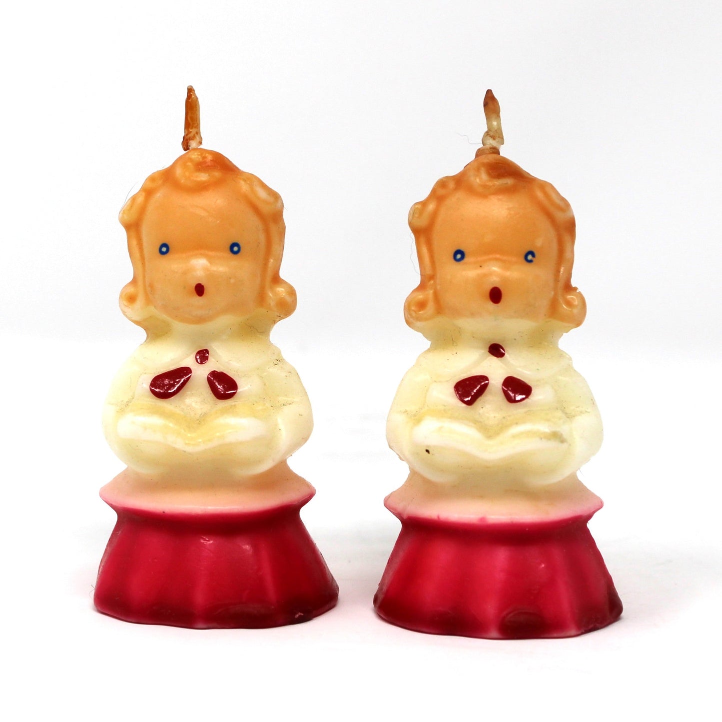 a vintage Gurley novelty candle shaped like a caroling girl with a white and red dress.  