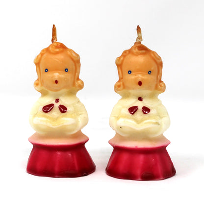 a vintage Gurley novelty candle shaped like a caroling girl with a white and red dress.  