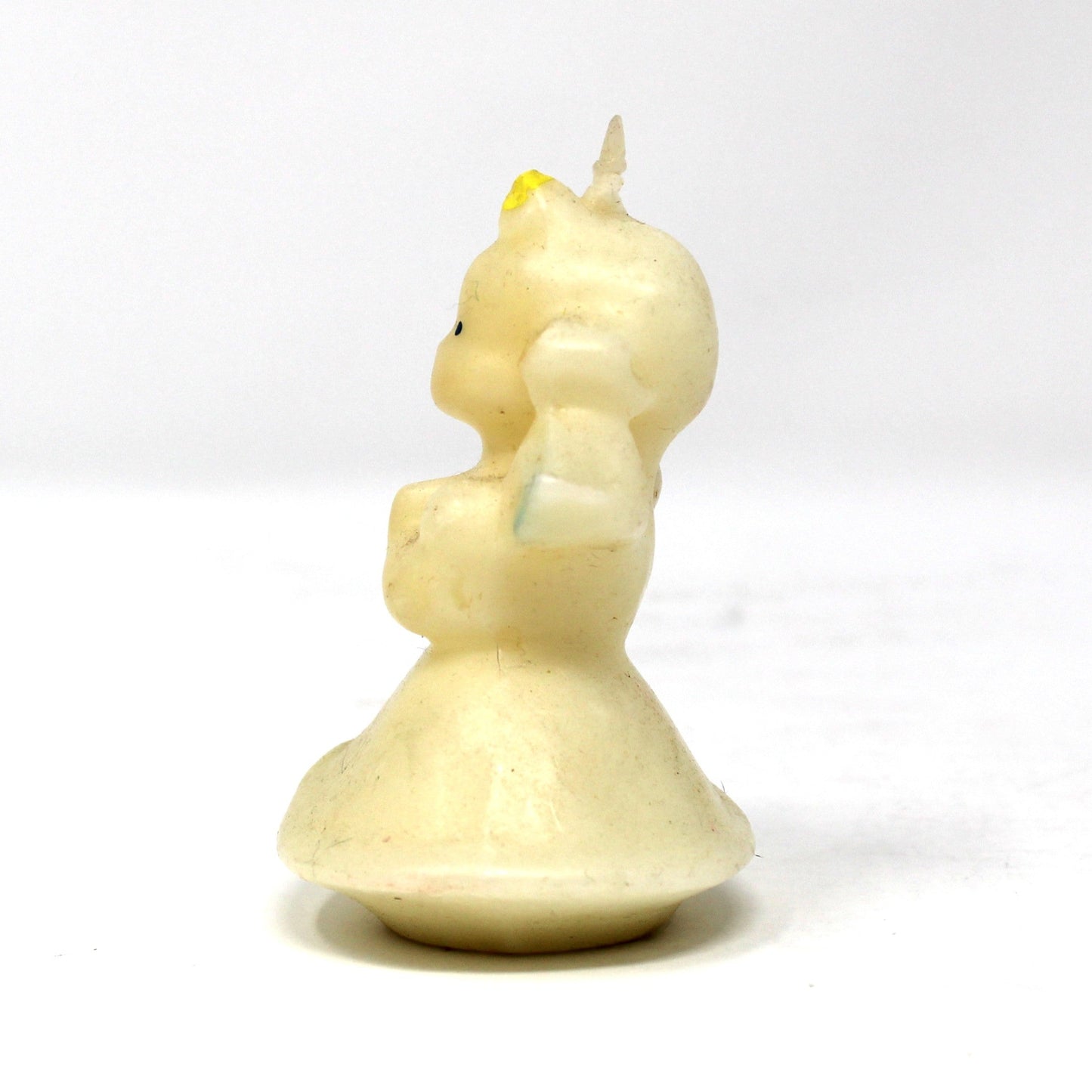 Side view of a vintage Gurley angel candle with blond hair and blue wings. 