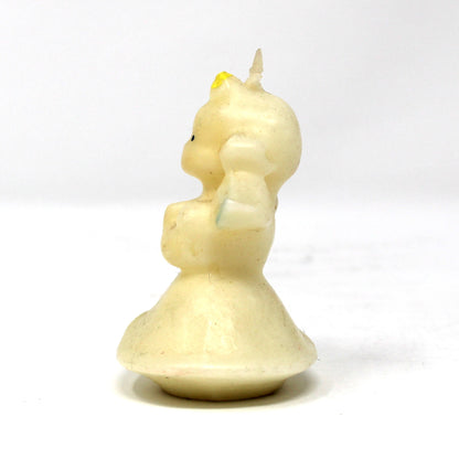 Side view of a vintage Gurley angel candle with blond hair and blue wings. 