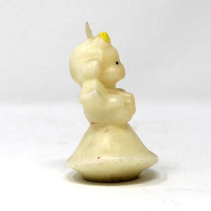 Side view of a vintage Gurley angel candle with blond hair and blue wings. 