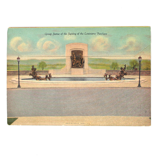 Back view of a vintage souvenir photo book postcards showing a monument or memorial scene with horses and people in a park
