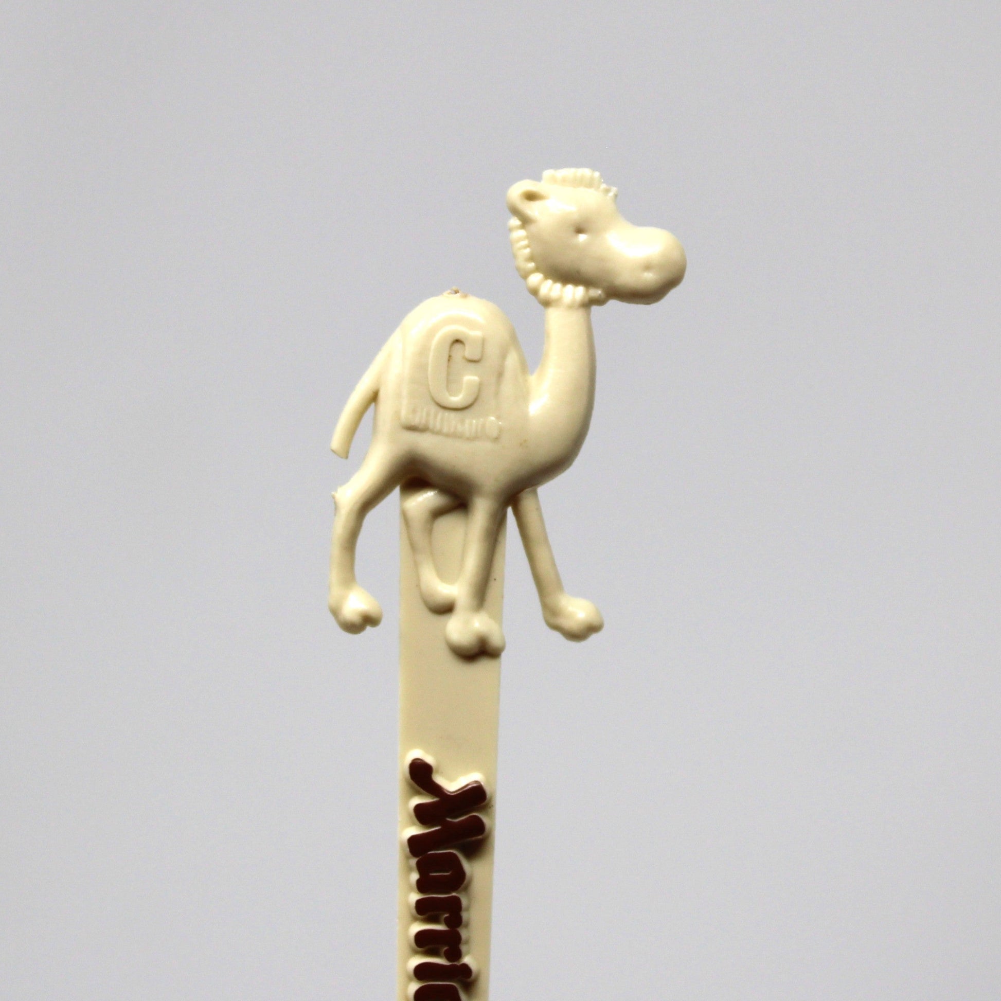 A vintage swizzle stick, cream-colored with a camel figure on top, from Marriott's Camelback Inn in Scottsdale.