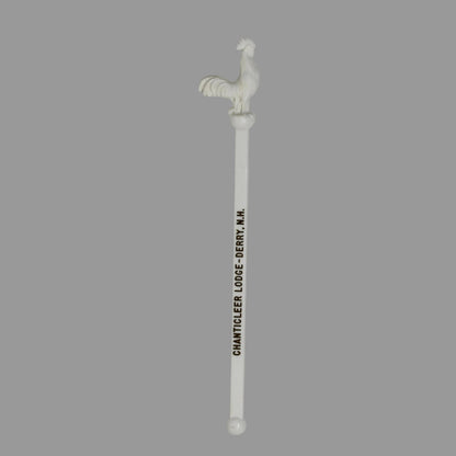 A vintage swizzle stick, cocktail stirrer with a rooster and goldprinted text reading 'CHANTICLEER LODGE'