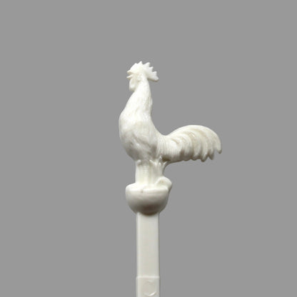 A vintage swizzle stick with a white rooster from The Barn on Beacon Street