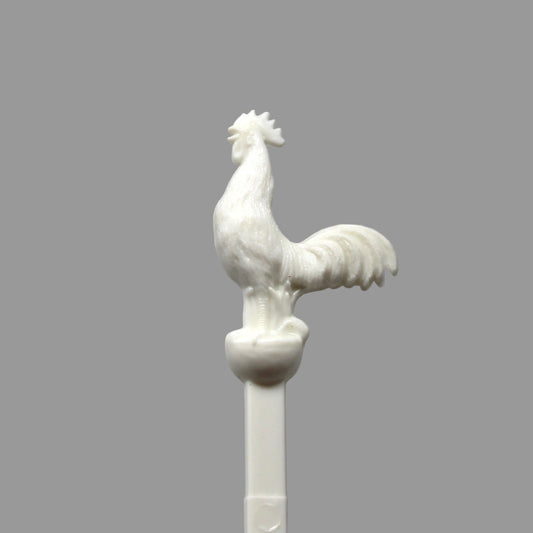A vintage swizzle stick with a white rooster from The Barn on Beacon Street