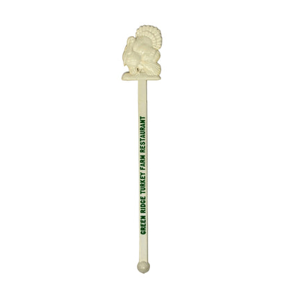 An off-white plastic cocktail stirrer with a carved lion head topper and green printed text reading 'GREEN ROSE TROUT FARM RESTAURANT', shown on a plain white background.
