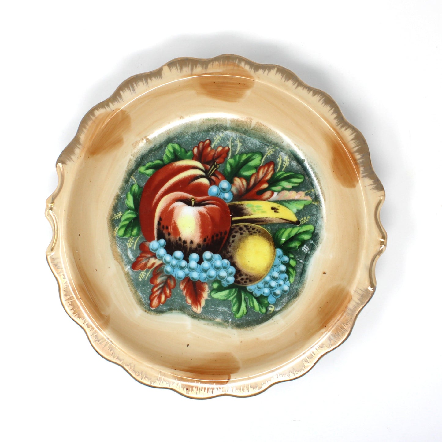 A view of the basin from a vintage Enesco ceramic pitcher and basin set with hand-painted fruit motifs, including red apples, yellow pears, and blue grapes.