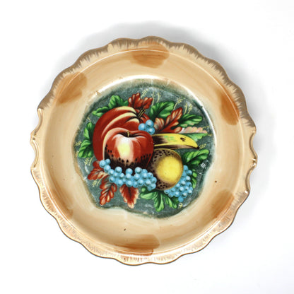 A view of the basin from a vintage Enesco ceramic pitcher and basin set with hand-painted fruit motifs, including red apples, yellow pears, and blue grapes.