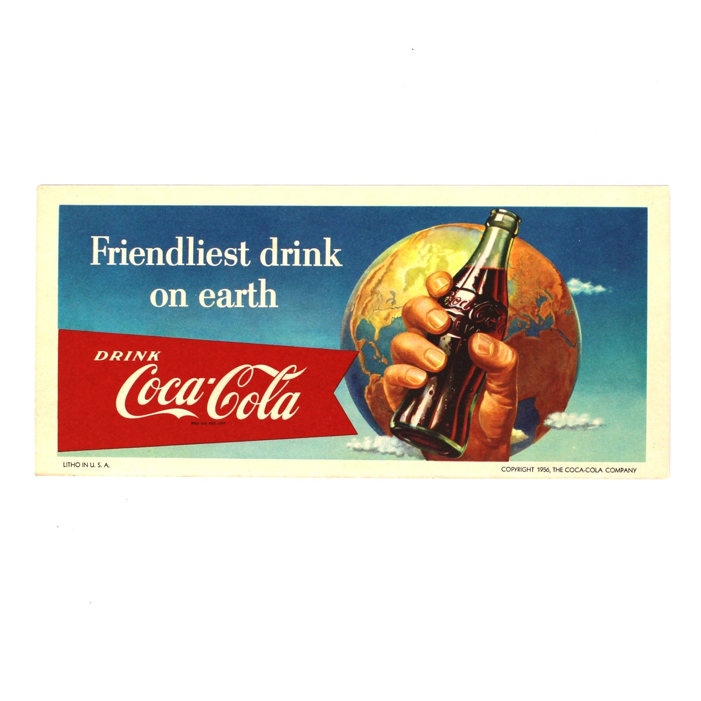 A vintage Coca-Cola advertisement ink blotter  featuring the slogan 'Friendliest drink on earth' with a hand holding a glass bottle against a blue sky and globe background.