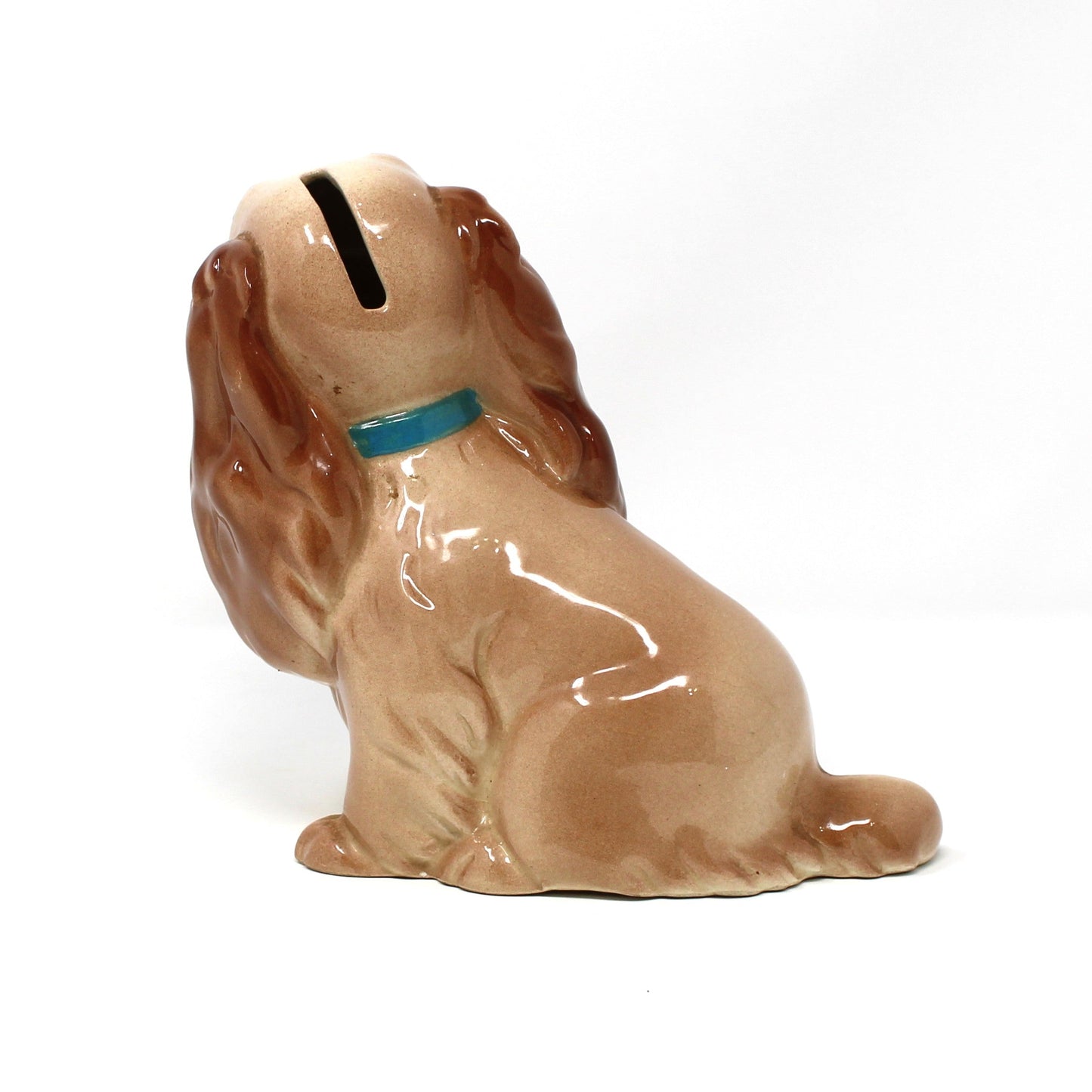 Back view of a vintage Hagen-Renaker ceramic coin bank.  Disney's "Lady" from the Movie, Lady and the Tramp. Cocker Spaniel dog wearing a small blue and yellow collar.