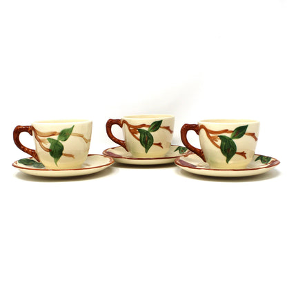 Back view of 3 vintage Franciscan Apple cups and saucers.  Hand painted apples and green leaves on a cream-colored background.