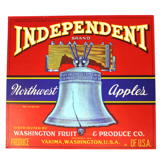 A vintage red crate label for Independent Brand Northwest Apples, featuring a large silver bell illustration and text for Washington Fruit & Produce Co. in Yakima, Washington.