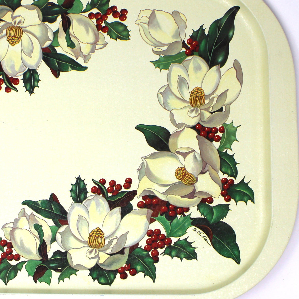 A vintage rectangular Christmas serving tray by Potpourri, with a cream-colored background, decorated with a border of white magnolia flowers, green holly leaves, and red berries.
