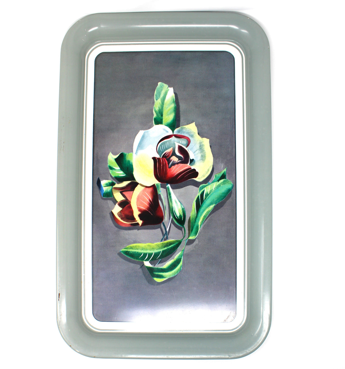 A rectangular vintage metal tray with rounded corners, featuring a painted floral design of white, red, and yellow flowers with green leaves on a dark gray background