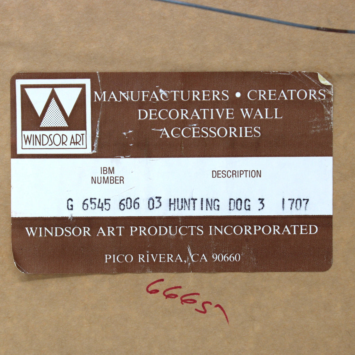 A brown paper label with the Windsor Art logo and text reading 'Manufacturers • Creators • Decorative Wall Accessories' with a IBM number, on a tan cardboard background.