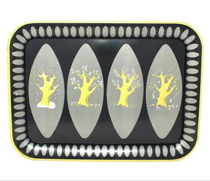 A decorative rectangular tray with rounded corners, featuring a black center, four vertical gray oval panels with yellow stylized four seasons tree designs, and a yellow border with a white dotted pattern.