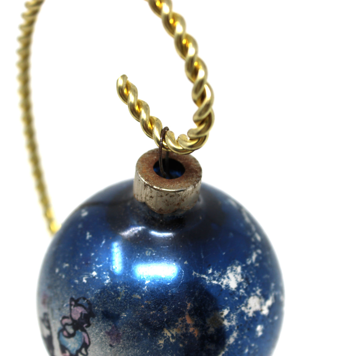 Top view of a very rusty metal cap on a vintage Mercury Glass Ball