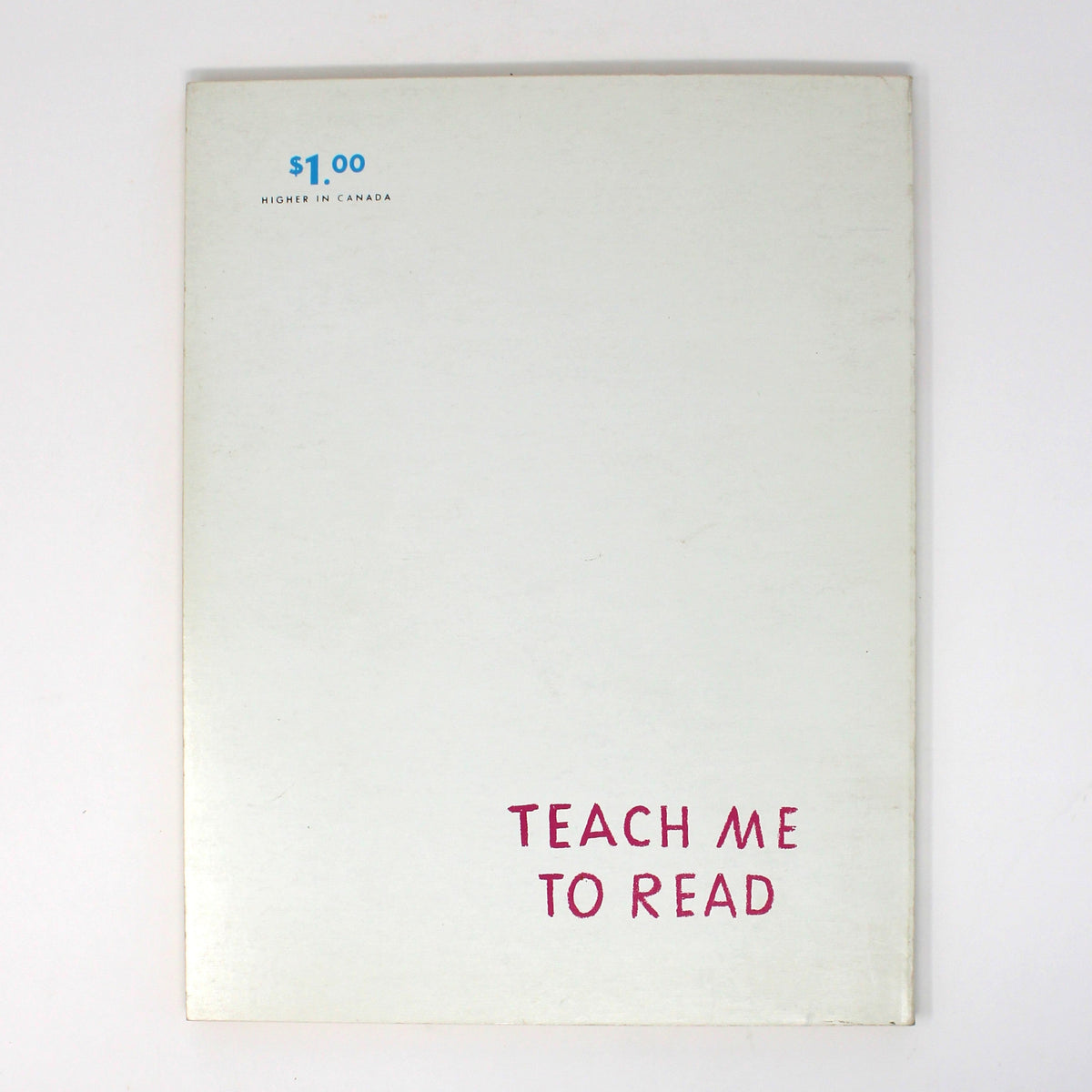 Back cover view of a vintage home schooling book, featuring the title 'TEACH ME TO READ' in pink text near the bottom and a small blue price mark  in the top left corner.