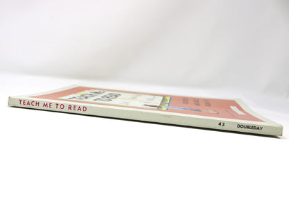 View of intact binding spine of a vintage children's book titled 'Teach Me To Read'.  Unused, dated 1959. 