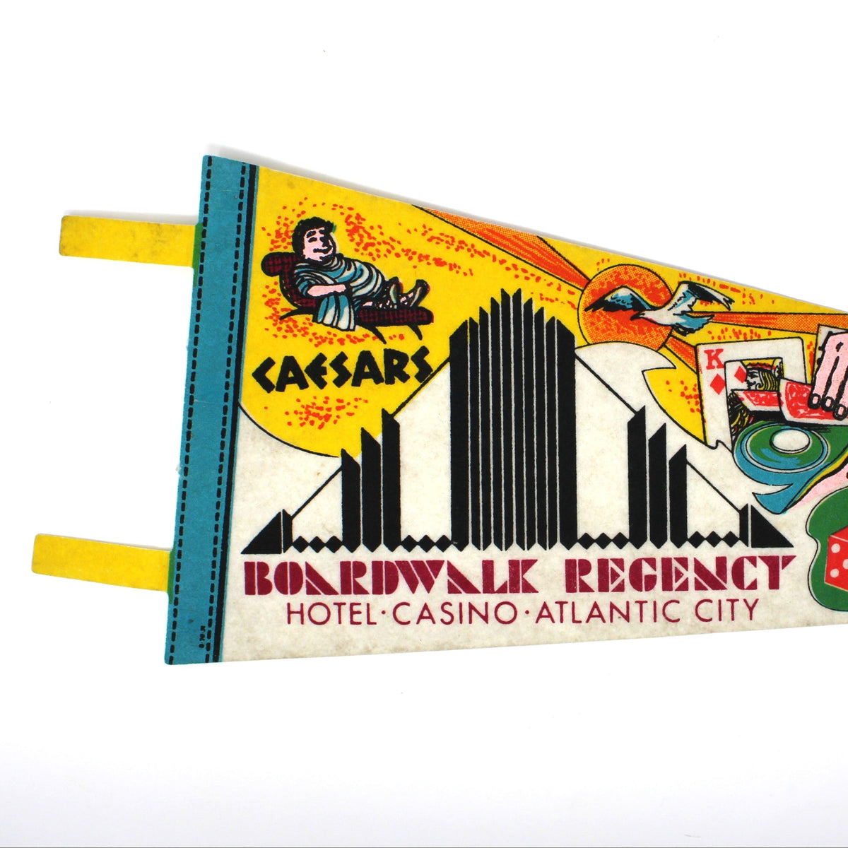 A vintage-style triangular felt pennant banner featuring colorful illustrations and text for 'Boardwalk Regency Hotel-Casino - Atlantic City,'. The pennant has a multicolor printed design with yellow tabs on the left side