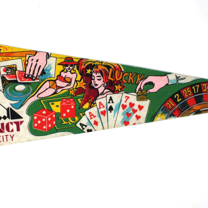 A vintage triangular felt pennant flag for the Boardwalk Regency Hotel Casino, featuring colorful illustrations of slot machines, cards, dice, and roulette, with a yellow cord on the left.