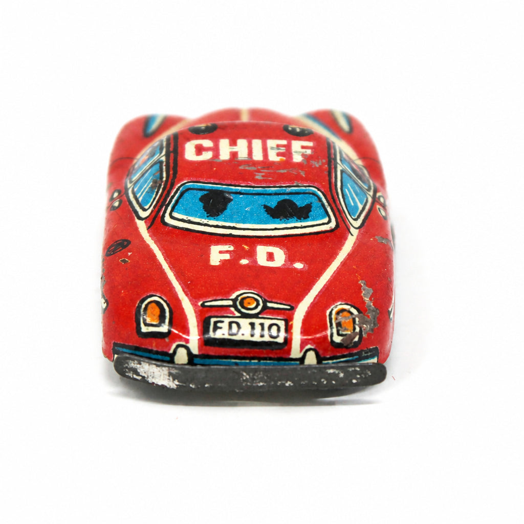 Back view of small 1950s Nakamura Japanese tin litho red Fire Chief penny toy car. 