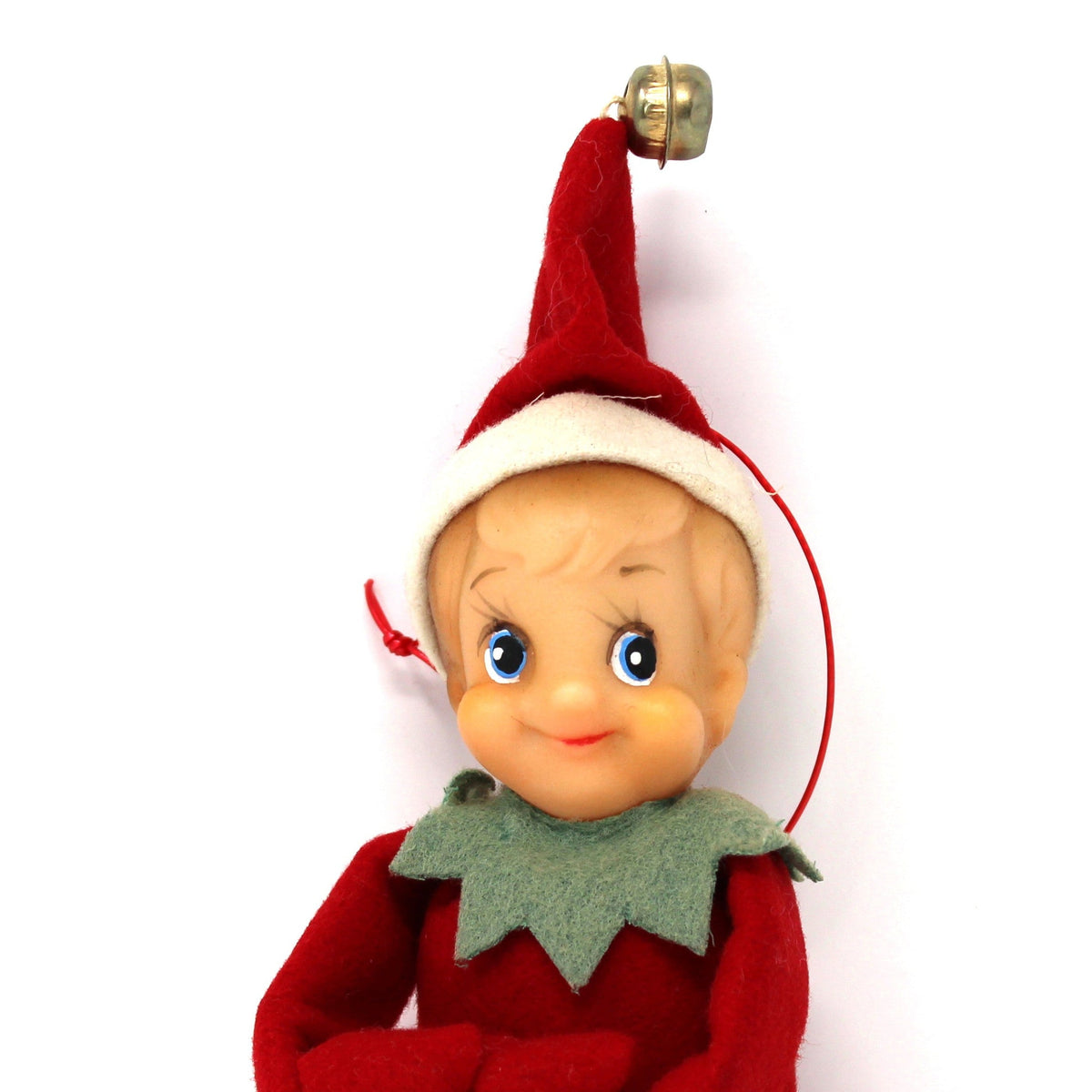 A vintage Christmas Elf doll hanging ornament, featuring a blonde plastic face, red velvet suit, green felt collar, and a gold bell on a red hat, set against a plain white background.